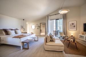 a bedroom with a large bed and a couch and a chair at Payava Hotel by True Blue in Kalkan +37 photos