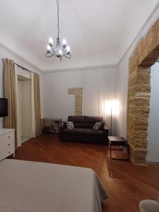 a living room with a couch and a table at Residenza del Massimo in Palermo +11 photos
