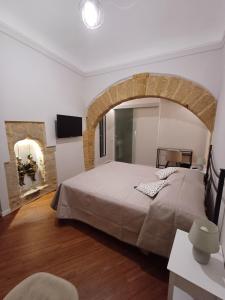 a bedroom with a large bed in a room at Residenza del Massimo in Palermo