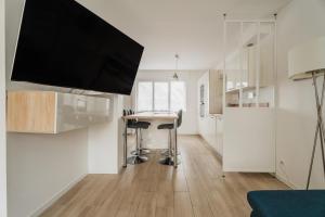 a kitchen with a table and stools in a room at Maison des Clos Biais in Dinard +14 photos