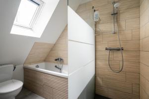 a bathroom with a toilet and a shower at Maison des Clos Biais in Dinard