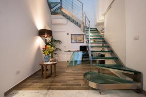 a hallway with stairs and a vase of flowers at Amalfi Luxury House in Amalfi