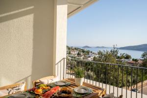 a table on a balcony with a view of the water at Payava Hotel by True Blue in Kalkan