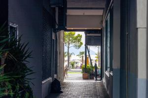 an alley way with a palm tree in the distance at Lungomare luxury apartament in Vlorë