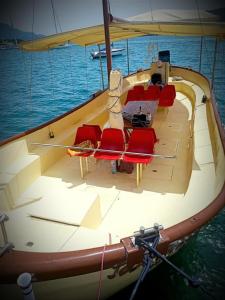 a boat with chairs and a table on the water at Jadranka Boat in Tivat