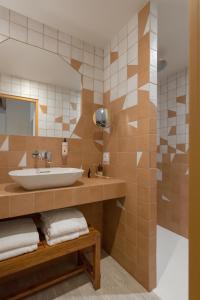 a bathroom with a sink and a mirror at Académie Hôtel Lyon in Lyon