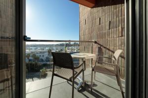 two chairs and a table on a balcony with a view at INNSiDE by Meliá Alicante Porta Maris in Alicante