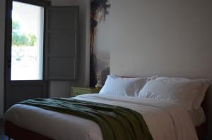 Postel nebo postele na pokoji v ubytování B&B Fuga al Trullo