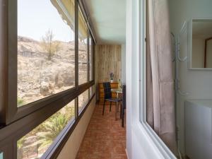 a room with a window and a table with a view at Amanecer Playa Patalavaca in Patalavaca