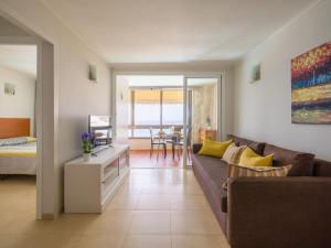 a living room with a couch and a table at Amanecer Playa Patalavaca in Patalavaca