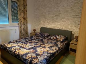 a bedroom with a bed and a brick wall at Casa Nich in Mangalia