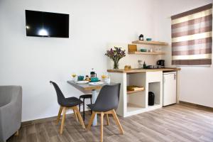 a kitchen and dining room with a table and chairs at Skalopati Studios & Villa in Panormos Skopelos