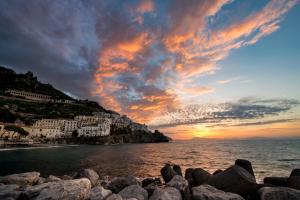 a sunset over positano on the amalfi coast at Amalfi Luxury House in Amalfi