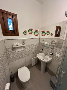 a bathroom with a toilet and a sink at Nostra casa rooms in Palermo