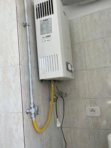 a boiler on the wall of a bathroom at Mahdia Appartement in Mahdia +16 photos