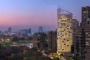 a city skyline with a tall building at night at Dusit Suites Hotel Ratchadamri, Bangkok in Bangkok