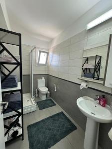 a bathroom with a sink and a toilet and a mirror at Royal Sun in Iskele