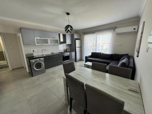 a kitchen and living room with a table and a couch at Royal Sun in Iskele