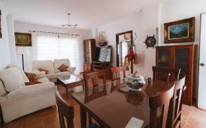 a living room with a table and chairs and a couch at Apartamento - Ático ISLA CANELA in Ayamonte