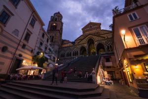 a group of people walking up the stairs of a building at Amalfi Luxury House in Amalfi
