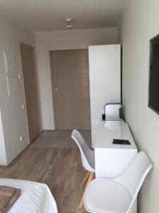 a white room with a desk and a printer on it at Pärnu Apartment in Pärnu