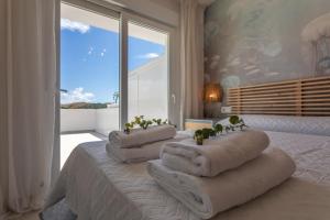 a bedroom with three pillows on a bed with a window at Terrace, sea view, pool, parking space & fibre in Tarifa +85 photos