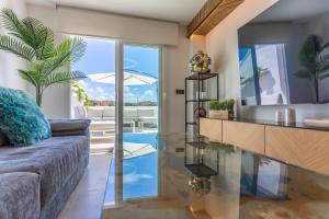 a living room with a couch and a glass table at Terrace, sea view, pool, parking space & fibre in Tarifa