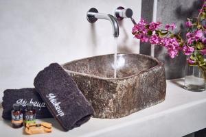 a sink with a faucet on top of a counter at Hippie Chic Hotel in Agios Ioannis Mykonos