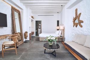 a living room with a couch and a table at Hippie Chic Hotel in Agios Ioannis Mykonos