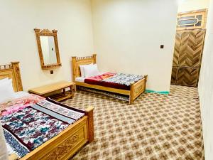 Postel nebo postele na pokoji v ubytování MANOKUR - E- BASA HOTEl