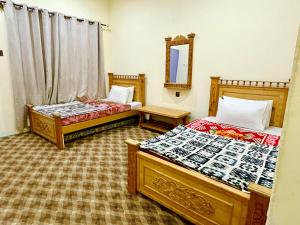 Postel nebo postele na pokoji v ubytování MANOKUR - E- BASA HOTEl