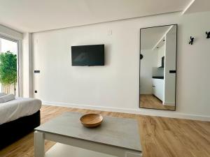 a living room with a mirror and a table at Apartamento Bambú in Torre del Mar