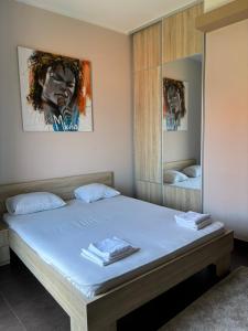 a bedroom with a large bed with a mirror at The Old Town Viewpoint Apartments in Budva