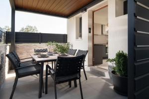 a patio with a table and chairs on a balcony at Villas THALLO in Paradisos
