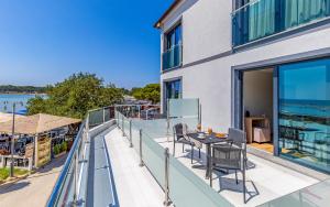 a balcony with a table and chairs on it at Hotel Koral in Medulin
