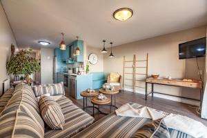 a living room with a couch and a table at Beachfront Luxury Living- A106 Seaspray, Blouberg in Bloubergstrand