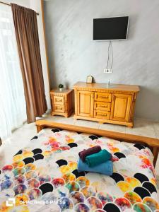 a bedroom with a bed with a television on the wall at Jeni's studio in Constanţa