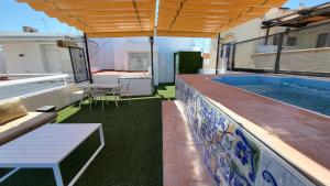 a balcony with a swimming pool on a building at RentalSevilla Real de la Carretería in Seville