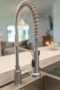 a kitchen sink with a chrome kitchen faucet at Villa Vista Verde Mijas Golf - Luxury with Optional heated pool & jacuzzi in Mijas