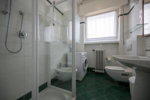 a bathroom with a shower and a toilet and a sink at Breathtaking view. in Malcesine +22 photos