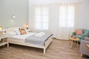 a bedroom with a bed and a desk and a chair at Skalopati Studios & Villa in Panormos Skopelos