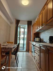 a kitchen with a table and a dining room at Jeni's studio in Constanţa