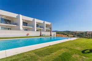 an image of a villa with a swimming pool at Terrace, sea view, pool, parking space & fibre in Tarifa