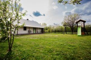 a house with a playground in a yard at Sielanka Roztocze in Pary