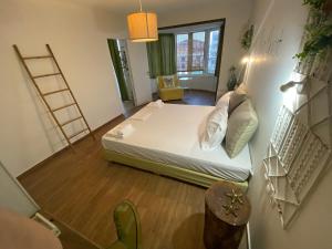 a small room with a bed and a ladder at KLIO Apartments and Studios in Nei Poroi