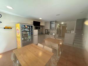 a kitchen with two tables and a refrigerator at Carpe Viam in Santo Domingo de la Calzada