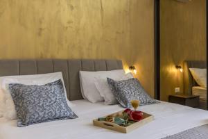 a tray of flowers on a bed with pillows at Zvonimir Holiday with large 95m2 pool in Solin +87 photos