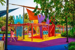 a playground in a park with people playing on it at Happy House in Ho Chi Minh City