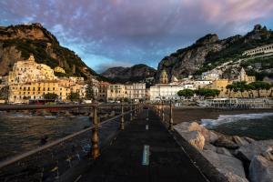 a town on a beach with mountains in the background at Amalfi Luxury House in Amalfi