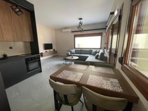 a living room with a table and a couch at Elia Luxury Apartments in Elaiokhórion